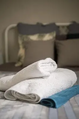 a pile of towels and a comb on a bed at Your stay next to Acropolis! in Athens