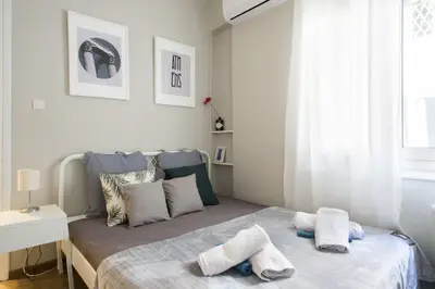 a bedroom with a bed with towels on it at Your stay next to Acropolis! in Athens