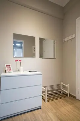 a white room with a mirror and a white dresser at Your stay next to Acropolis! in Athens
