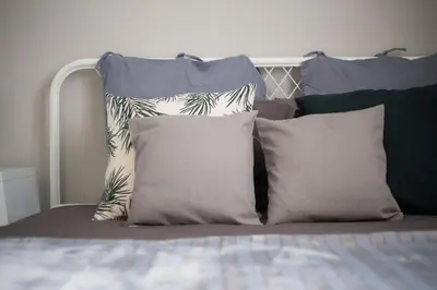 a group of pillows sitting on top of a bed at Your stay next to Acropolis! in Athens