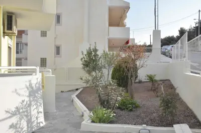 a courtyard with plants on the side of a building at Double M near Athens Airport in Markopoulo