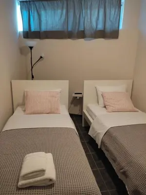 two beds sitting next to each other in a room at Double M near Athens Airport in Markopoulo