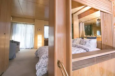 a bedroom with a bed and a large mirror at One-of-a-kind Athens Riviera Apartment in Athens