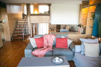 a living room with a couch with colorful pillows at One-of-a-kind Athens Riviera Apartment in Athens