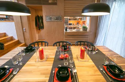 a long wooden table with chairs and plates and glasses at One-of-a-kind Athens Riviera Apartment in Athens