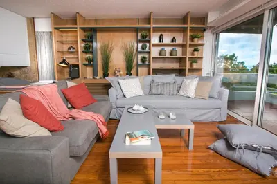a living room with two couches and a table at One-of-a-kind Athens Riviera Apartment in Athens