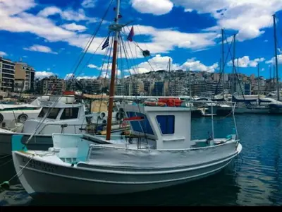 a white boat is docked in a harbor at Φωτεινό διαμέρισμα Πειραιας in Piraeus