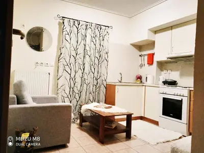 a living room with a couch and a table at Φωτεινό διαμέρισμα Πειραιας in Piraeus
