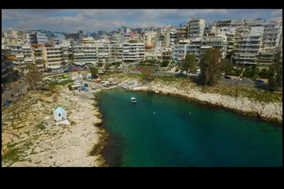 an aerial view of a beach with buildings and a city at Φωτεινό διαμέρισμα Πειραιας in Piraeus