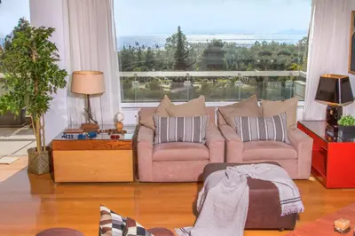 a living room with two couches and a large window at Athens luxurious apartment - sea view! in Athens