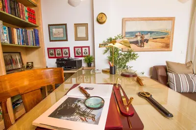a living room with a table with a book at Athens luxurious apartment - sea view! in Athens