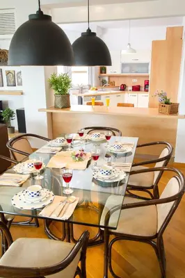 a dining room table with chairs and glasses of wine at Athens luxurious apartment - sea view! in Athens