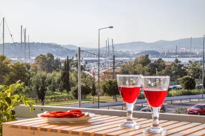 two glasses of red wine sitting on a table at Athens luxurious apartment - sea view! in Athens