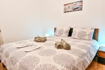 a bed with towels and shoes on top of it at Manolitos Apartments 5 in Athens