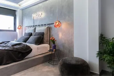 a bedroom with a bed and a wall with hello sign at 14 Reasons Why Hotel Athens in Athens