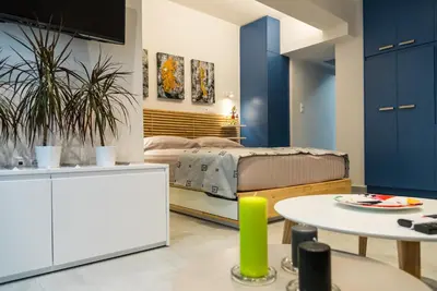 a living room with a bed and a table at Central Cozy Studio with a Secret Garden in Athens