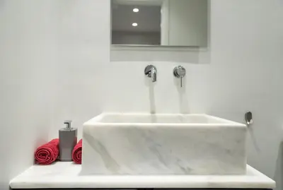 a white sink with two faucets in a bathroom at Central Cozy Studio with a Secret Garden in Athens