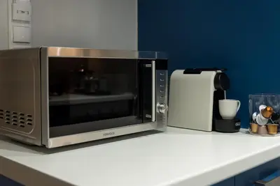 a microwave sitting on top of a kitchen counter at Central Cozy Studio with a Secret Garden in Athens