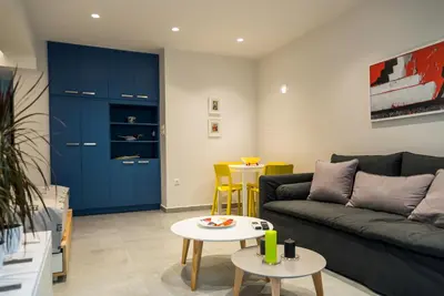 a living room with a couch and a table at Central Cozy Studio with a Secret Garden in Athens