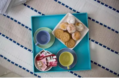 a blue tray with a plate of donuts and drinks at At Trendy Glyfada's Center in Athens