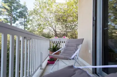 a chair sitting on the balcony of a house at At Trendy Glyfada's Center in Athens
