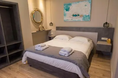 a bedroom with a bed with two towels on it at Wisdom Residence Luxury Apartments at Plaka in Athens