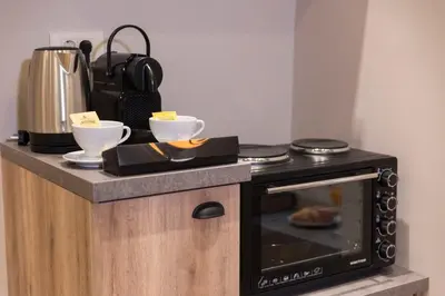 a counter with two bowls and a microwave at Wisdom Residence Luxury Apartments at Plaka in Athens
