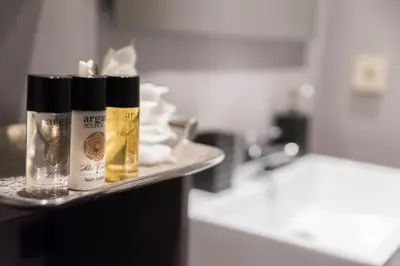 a counter with two bottles ofmetics at Wisdom Residence Luxury Apartments at Plaka in Athens