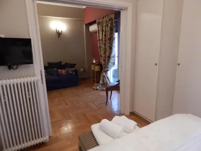 a living room with a couch and a tv at Athens-Plaka, Peter’s beautiful apartment in Temple of Zeus in Athens