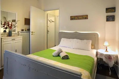 a bedroom with a bed with two towels on it at Aristotle's studio apartment in Athens