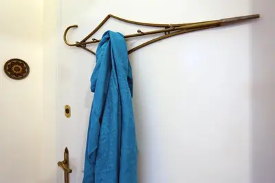 a blue towel hanging on a rail in a bathroom at Aristotle's studio apartment in Athens