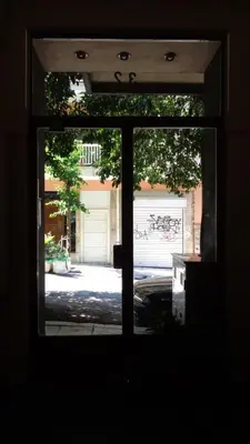 a view from a window of a street with a garage at Aristotle's studio apartment in Athens