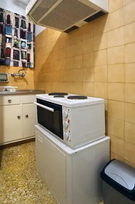 a kitchen with a white stove and a sink at Aristotle's studio apartment in Athens