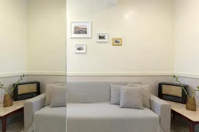 a living room with a couch and a tv at Athenian Lofts in Athens