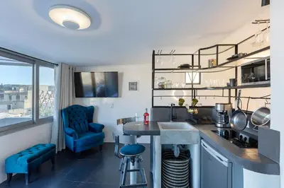 a kitchen with blue chairs and a table in a room at Athenian Lofts in Athens