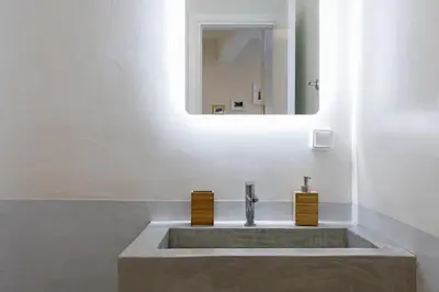 a bathroom with a sink and a mirror at Athenian Lofts in Athens