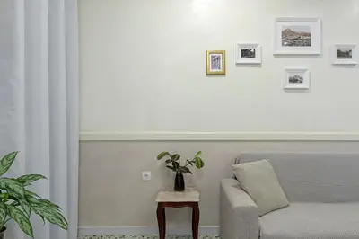 a living room with a couch and a table with a plant at Athenian Lofts in Athens