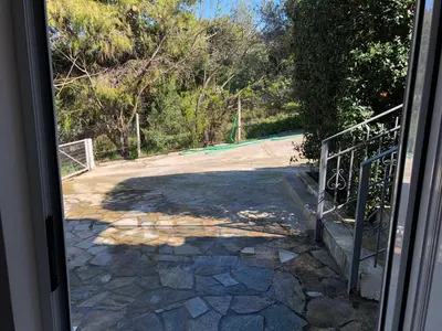 an open door to a driveway with a gate at Villa Sophia in Porto Rafti