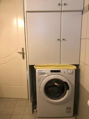 a washer and dryer in a bathroom with a cabinet at Villa Sophia in Porto Rafti
