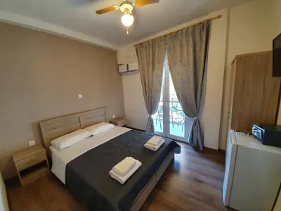 a bedroom with a bed with two towels on it at City Centre Stylish rooms in Athens