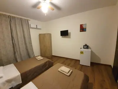 a small room with two beds and a television at City Centre Stylish rooms in Athens