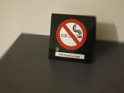 a no smoking sign sitting on top of a table at City Centre Stylish rooms in Athens