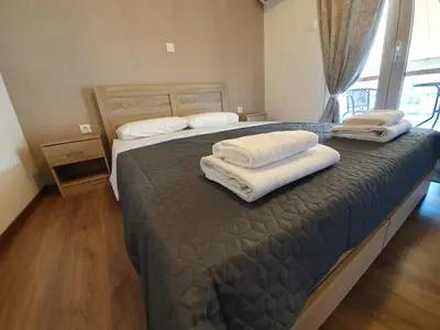 a bedroom with a large bed with towels on it at City Centre Stylish rooms in Athens
