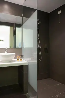 a bathroom with a sink and a shower at Athens Center Square Hotel in Athens