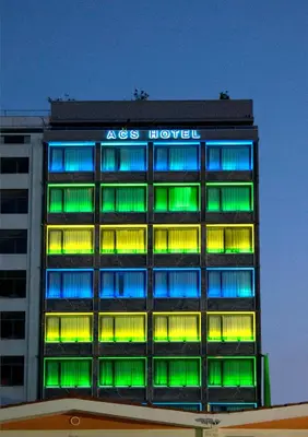 a building with green and blue lights on it at Athens Center Square Hotel in Athens
