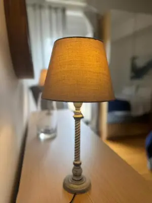 a lamp sitting on top of a wooden table at Ermou 44 - 3bdr Apartment in Athens