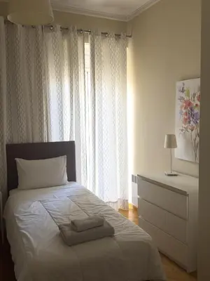 a bedroom with a bed with two towels on it at Ermou 44 - 3bdr Apartment in Athens
