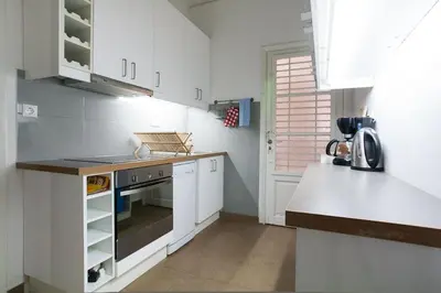 a kitchen with white cabinets and a stove top oven at Ermou 44 - 3bdr Apartment in Athens