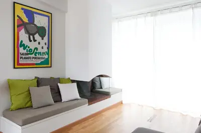 a couch sitting in a living room next to a window at Homz AH02 Kolonaki Penthouse Studio in Athens