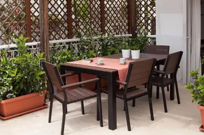 a wooden table and chairs on a patio at Homz AH02 Kolonaki Penthouse Studio in Athens